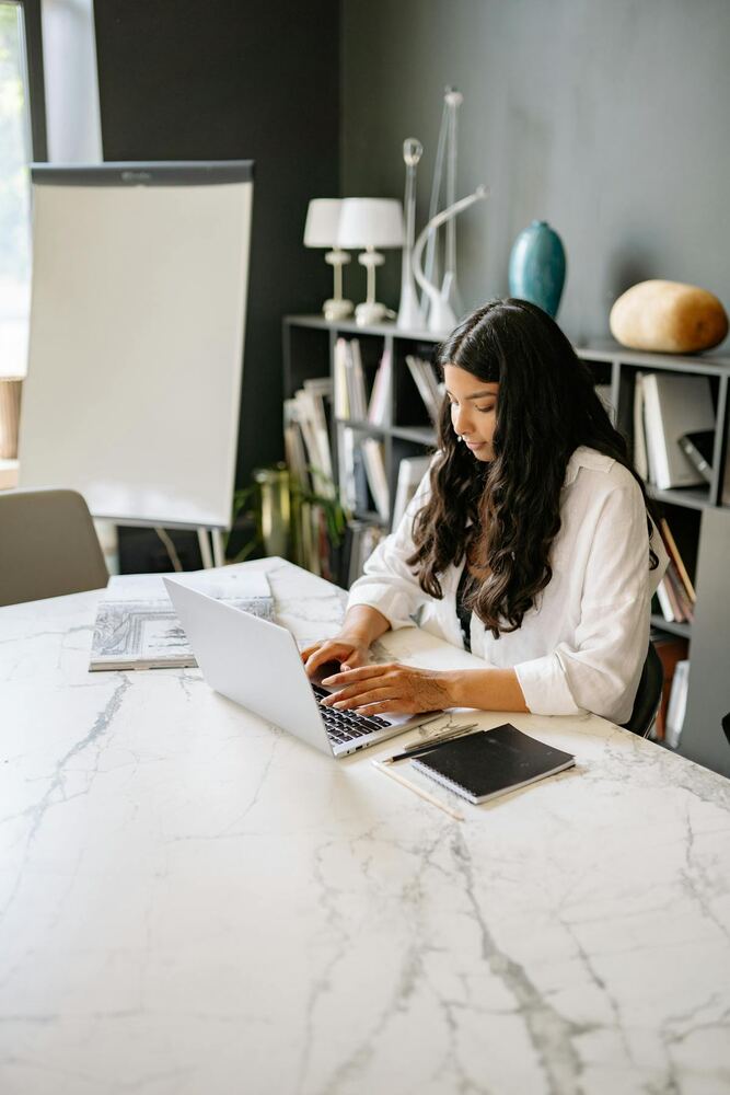 Team member using a laptop in an office workspace