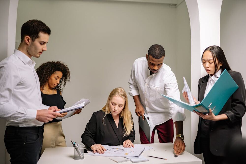 Professionals reviewing documents together in a modern office